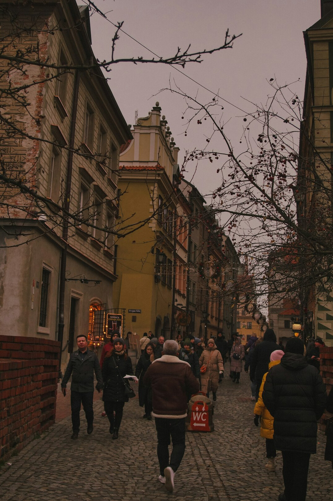 Everyday street life scene in a small Polish town with residents walking