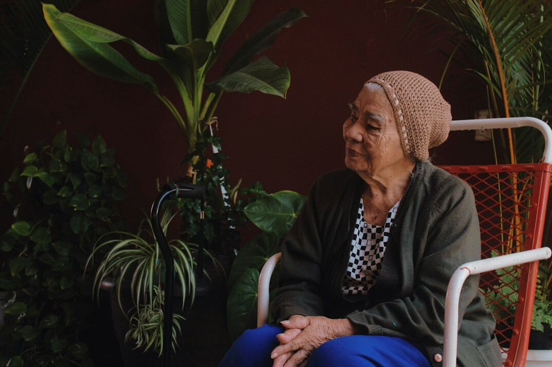 Photographer interviewing an elderly Polish woman seated in her kitchen